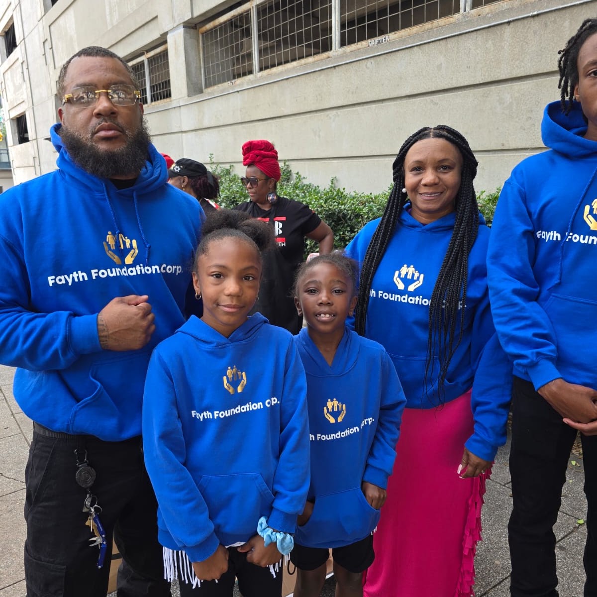 Charles and Ricketa Atkins with young volunteers in Fayth Foundation shirts