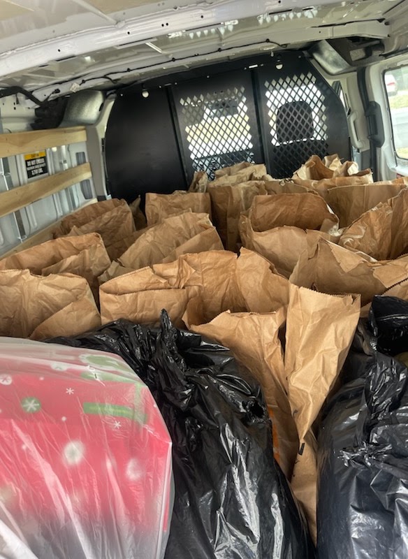 A van loaded with grocery bags ready for delivery